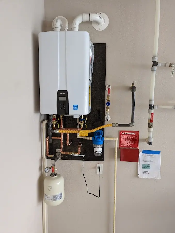 Professional plumber installing copper piping in a Somerville home